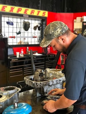 Master mechanic certified transmission specialist performing rebuild at our transmission shop 