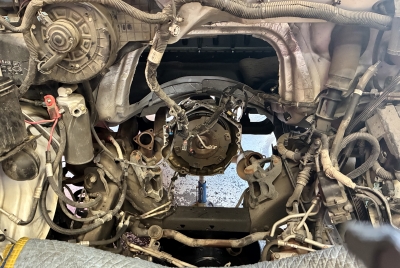 Empty Engine Bay of Chevy Express Van After Engine Removal