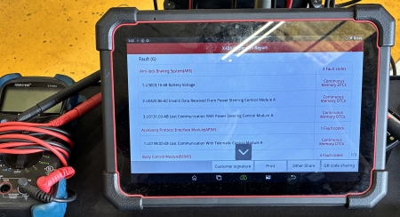 Diagnostic results show error codes indicating lost communication with the power steering control module.