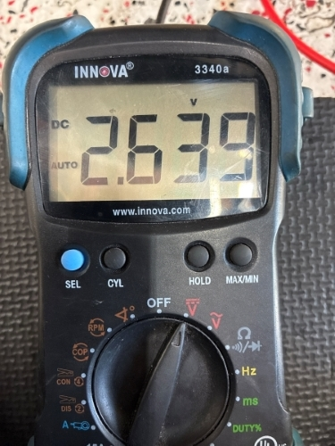 Multimeter showing the voltage drop during ABS diagnostics on Ford Transit 2 - Auto Repair San Antonio | Auto Service Experts Voltage drop shown on multimeter diagnostic tool during ABS repair on Ford Transit at Auto Service Experts San Antonio auto repair shop.