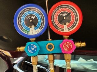 Car AC diagnostic by Hill Country Villages best mechanics - Auto Repair San Antonio | Auto Service Experts Diagnostic equipment taking pressure readings during free auto ac check in Hill Country Village at Auto Service Experts.