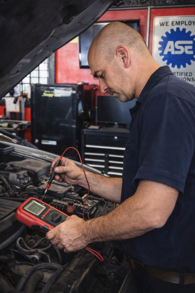 ASE Technician Performing Electrical Diagnostics in Shavano Park Auto Repair Shop - Auto Repair San Antonio | Auto Service Experts ASE certified technician testing vehicle electrical system at Auto Service Experts serving Shavano Park
