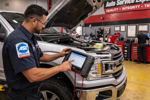 Auto diagnostic on Ford F150 to determine performance repair and maintenance needs - Auto Repair San Antonio | Auto Service Experts ASE Master technician using scan tool during vehicle maintenance in a top performing San Antonio shop.