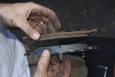 Brake pad thickness comparison during scheduled brake inspection in San Antonio.