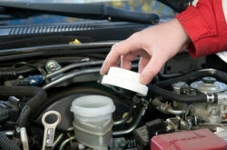 Auto-Service-Experts-Brake-Fluid-Reservoir-Inspection-San-Antonio-TX - Auto Repair San Antonio | Auto Service Experts Technician inspecting brake fluid reservoir level at Auto Service Experts in San Antonio.