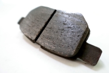 auto-service-experts-normal-brake-pad-friction-wear-san-antonio - Auto Repair San Antonio | Auto Service Experts Close-up of worn brake pad friction material demonstrating normal brake pad thickness wear.
