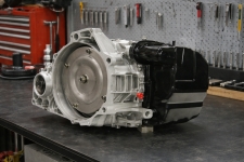 ford-fusion-4f27e-automatic-transmission-case – Auto Repair San Antonio | Auto Service Experts Side view of a Ford Edge FN4A-EL transmission on a bench with visible housing details and connectors, carefully reviewed at Auto Service Experts in San Antonio for proper operation