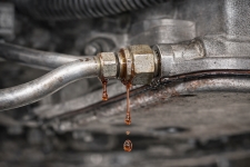 transmission-cooler-line-fitting-leak-san-antonio – Auto Repair San Antonio | Auto Service Experts leaking transmission fluid at the cooler line connection where corrosion and vibration caused the fitting to fail, identified by our team here in San Antonio during a pressure test